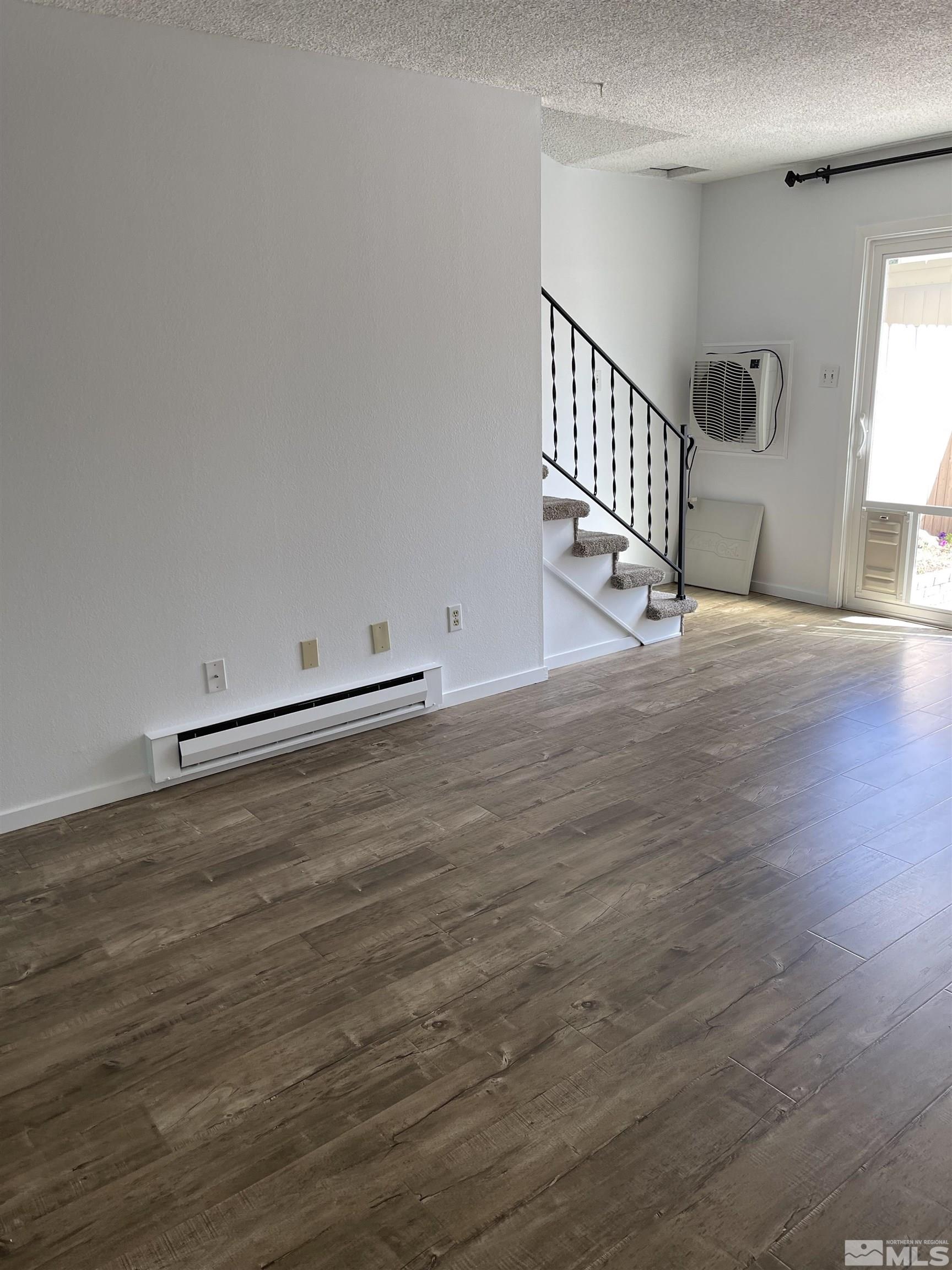 325 Smithridge Park Reno, NV 89502 - Photo 9 of 16 an empty room with wooden floor and windows