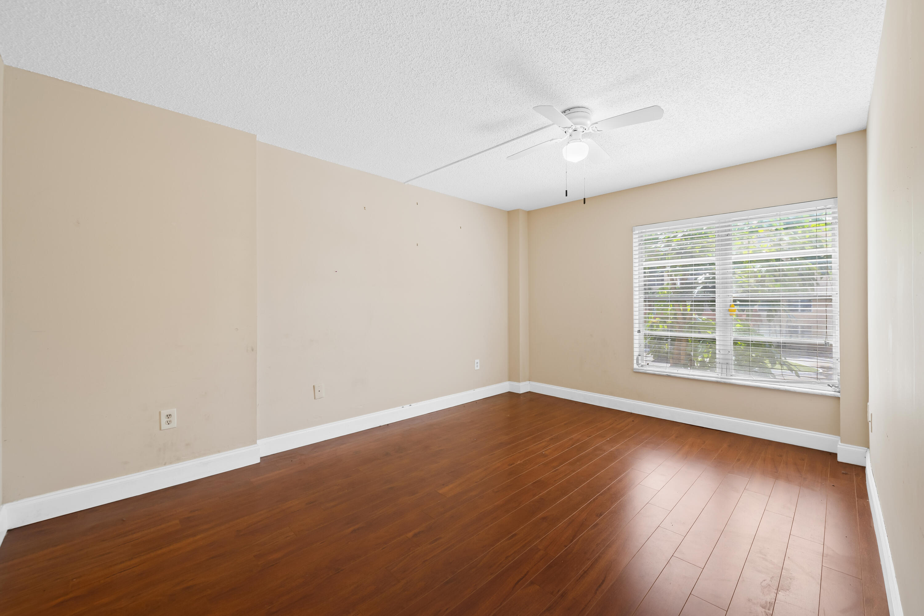 4156 Inverrary Drive, Unit 210 Lauderhill, FL 33319 - Photo 6 of 27 wooden floor in an empty room with a window