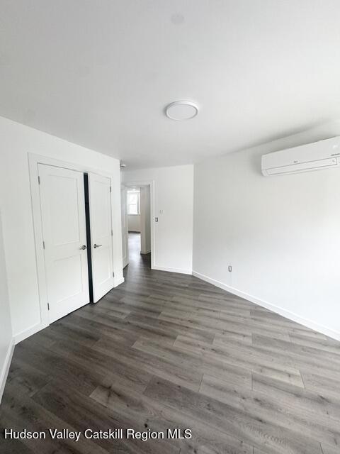 473 Main Street, Unit 1 Catskill, NY 12414 - Photo 7 of 8 a view of a big room with wooden floor and cabinet