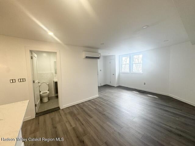 473 Main Street, Unit 1 Catskill, NY 12414 - Photo 8 of 8 an empty room with wooden floor and windows