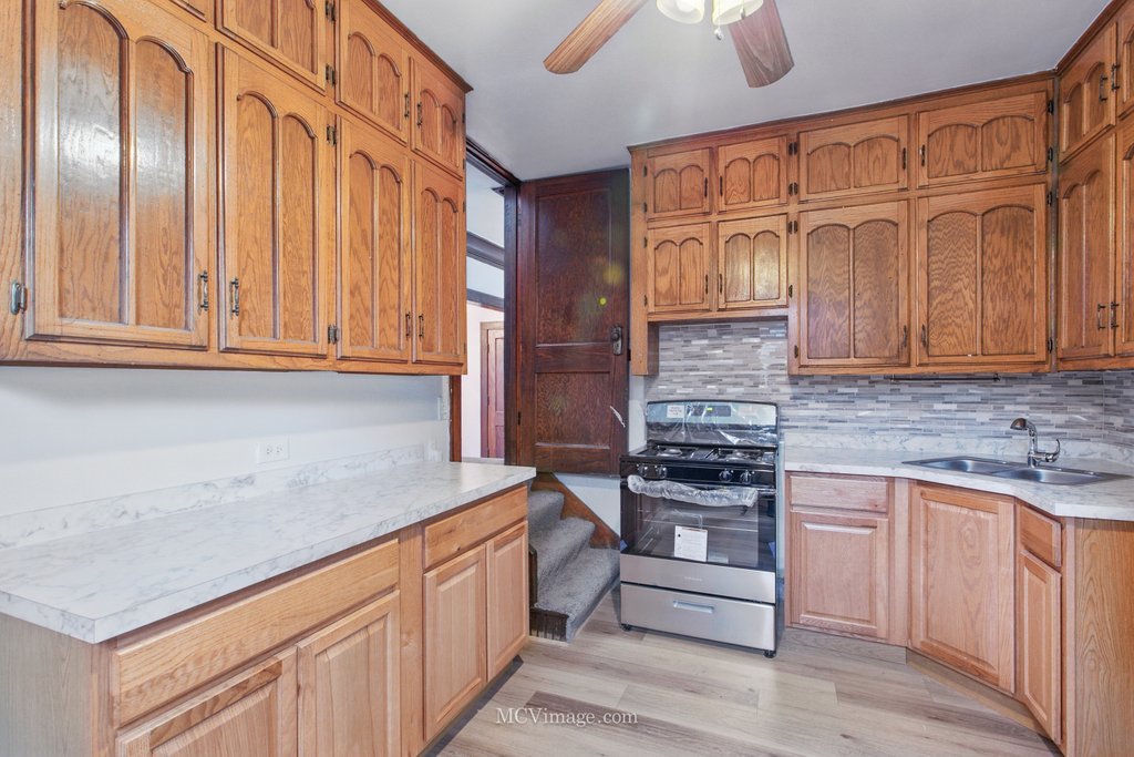 10130 South Lowe Avenue Chicago, IL 60628 - Photo 11 of 23 a kitchen with stainless steel appliances granite countertop a stove and a granite counter tops