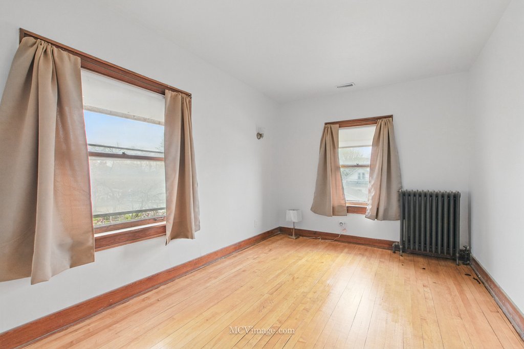 10130 South Lowe Avenue Chicago, IL 60628 - Photo 16 of 23 an empty room with wooden floor and windows