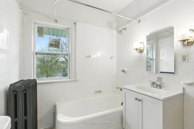 a white bath tub sitting next to a white sink