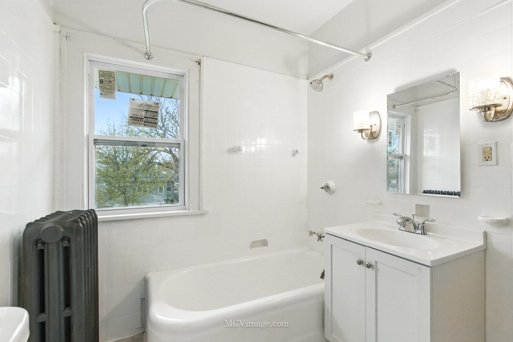 10130 South Lowe Avenue Chicago, IL 60628 - Photo 17 of 23 a white bath tub sitting next to a white sink