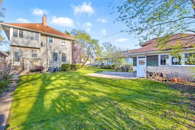 a view of house with yard and green space