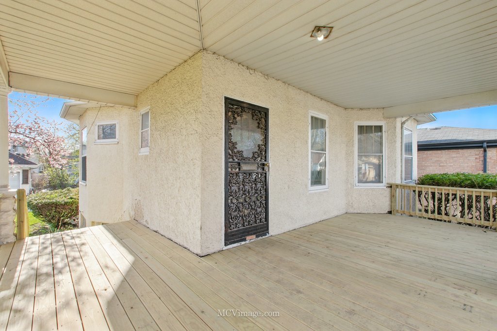 10130 South Lowe Avenue Chicago, IL 60628 - Photo 3 of 23 a view of a porch with wooden floor and fence