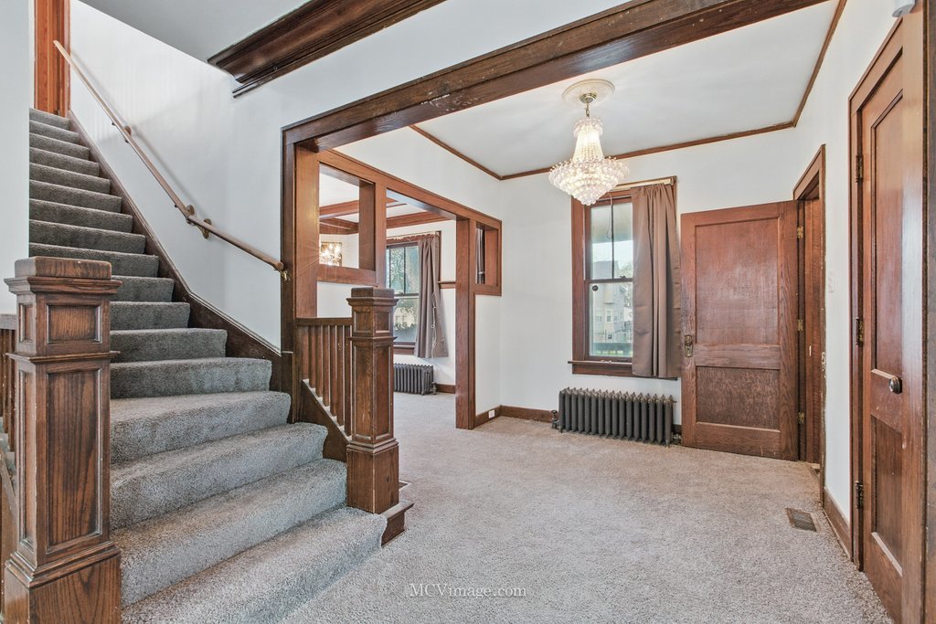 10130 South Lowe Avenue Chicago, IL 60628 - Photo 5 of 23 a view of entryway and hall with wooden floor and windows