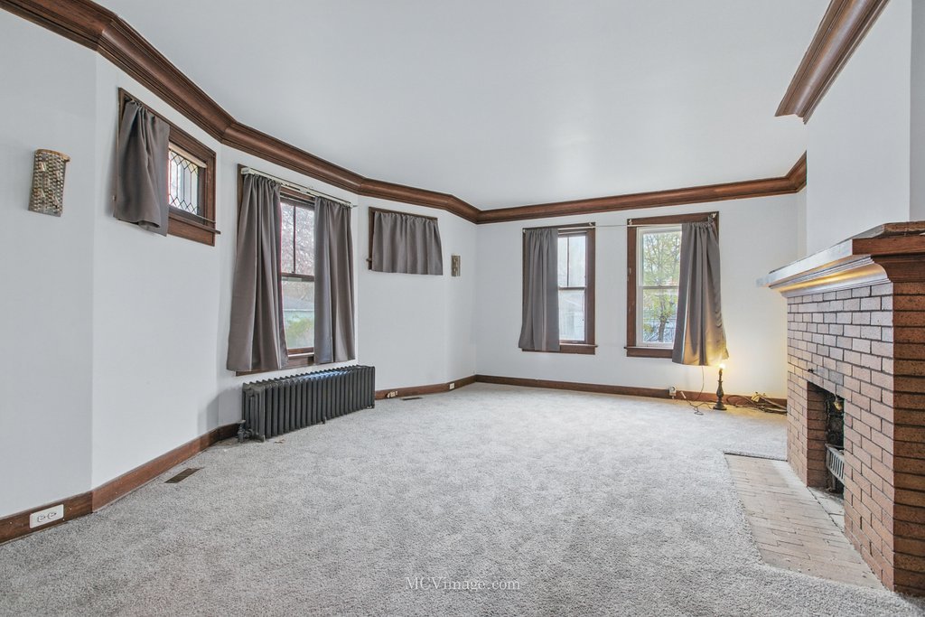 10130 South Lowe Avenue Chicago, IL 60628 - Photo 6 of 23 a view of an empty room with fireplace and a window