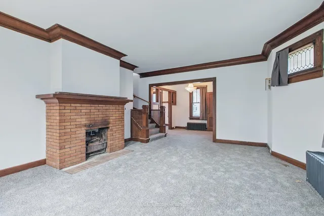 an empty room with furniture and a fireplace