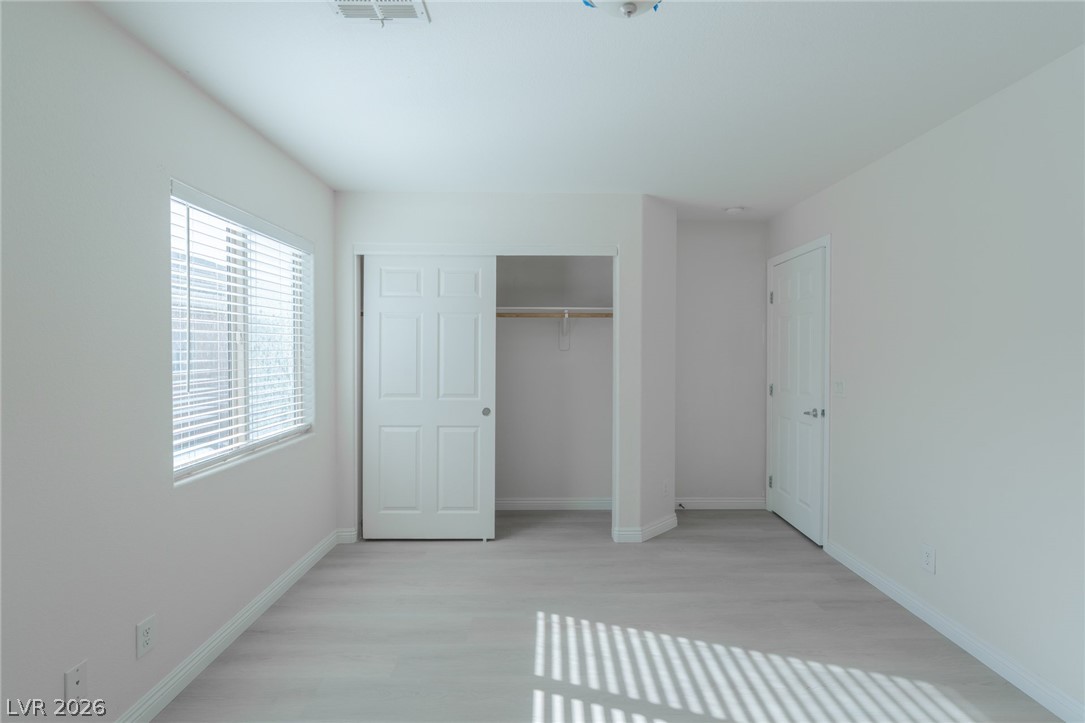 8079 Buffalo Ranch Avenue Las Vegas, NV 89147 - Photo 17 of 29 Clean lines and light flooring define this versatile secondary bedroom space.