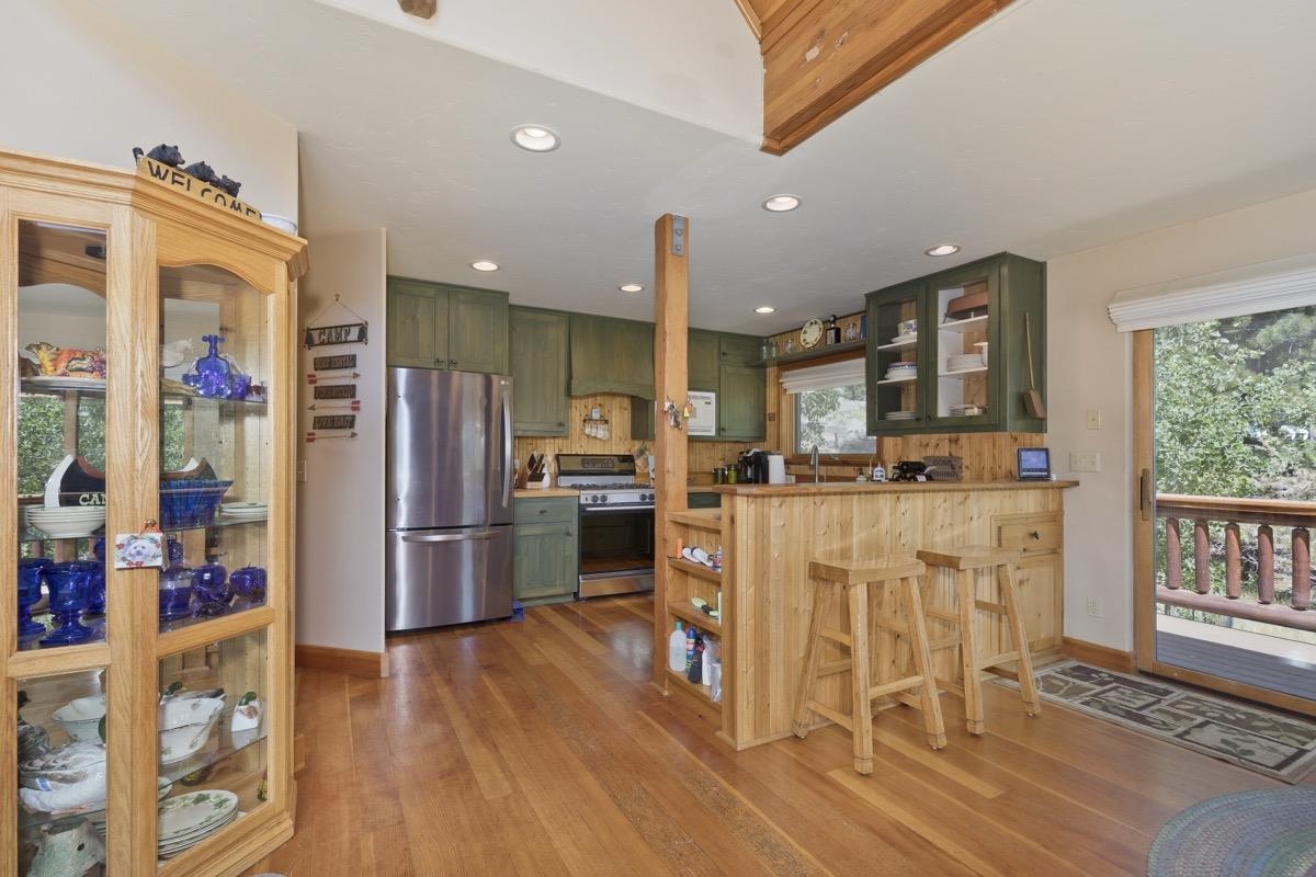 11650 Twin Lakes Road Bridgeport, CA 93517 - Photo 15 of 39 Kitchen featuring green cabinets, appliances with stainless steel finishes, light wood-type flooring, and recessed lighting
