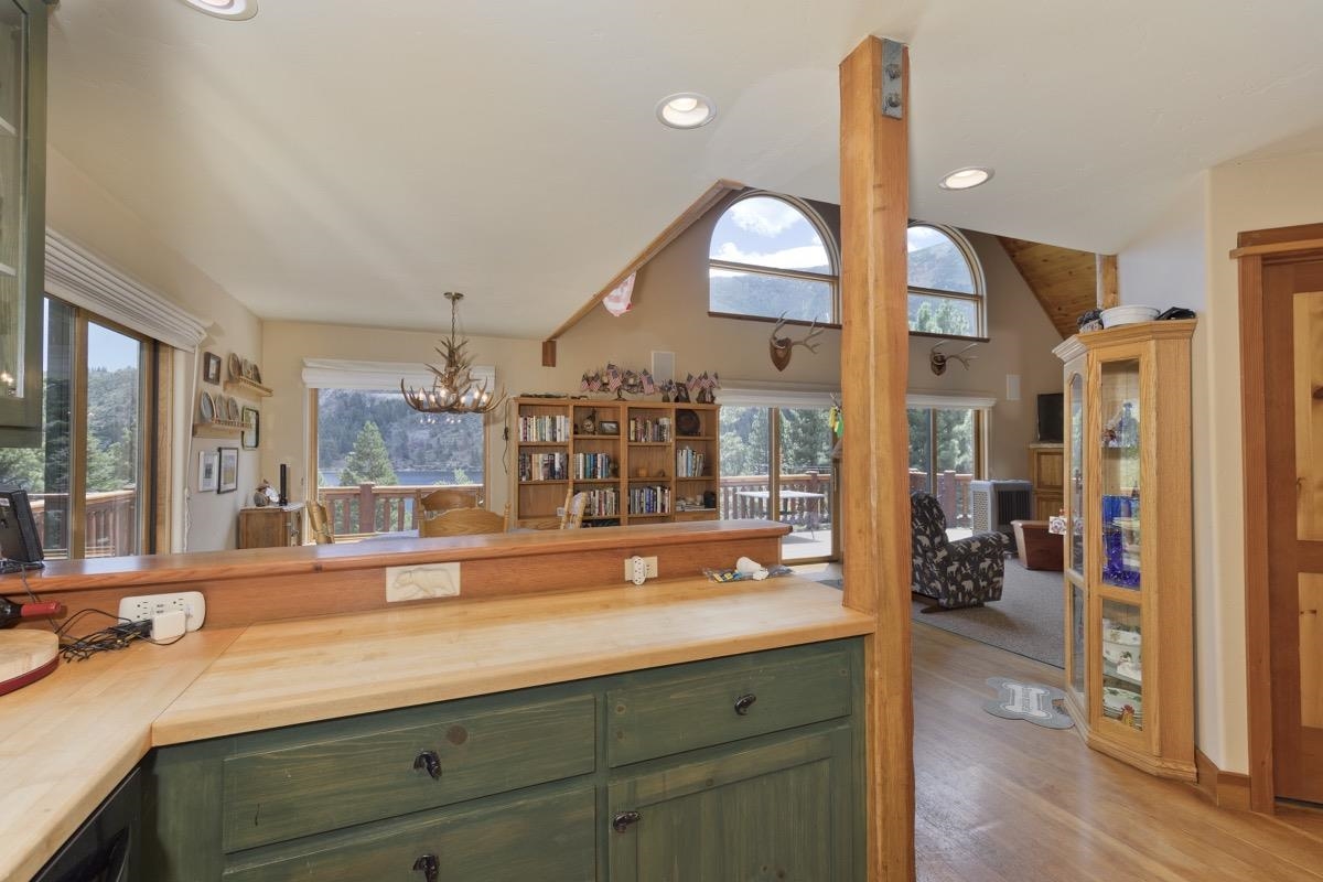 11650 Twin Lakes Road Bridgeport, CA 93517 - Photo 18 of 39 Kitchen featuring green cabinetry, butcher block counters, vaulted ceiling, light wood-type flooring, and healthy amount of natural light