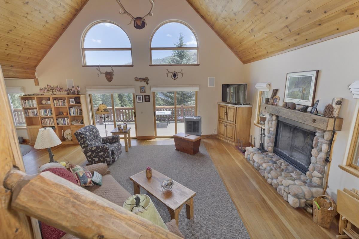 11650 Twin Lakes Road Bridgeport, CA 93517 - Photo 33 of 39 Living area with wooden ceiling, light wood-style floors, a stone fireplace, and high vaulted ceiling