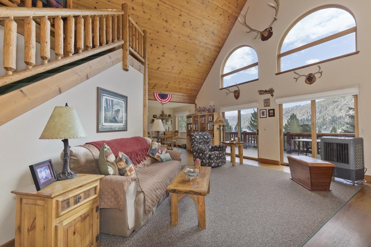 Living room featuring wooden ceiling, high vaulted ceiling, and wood finished floors