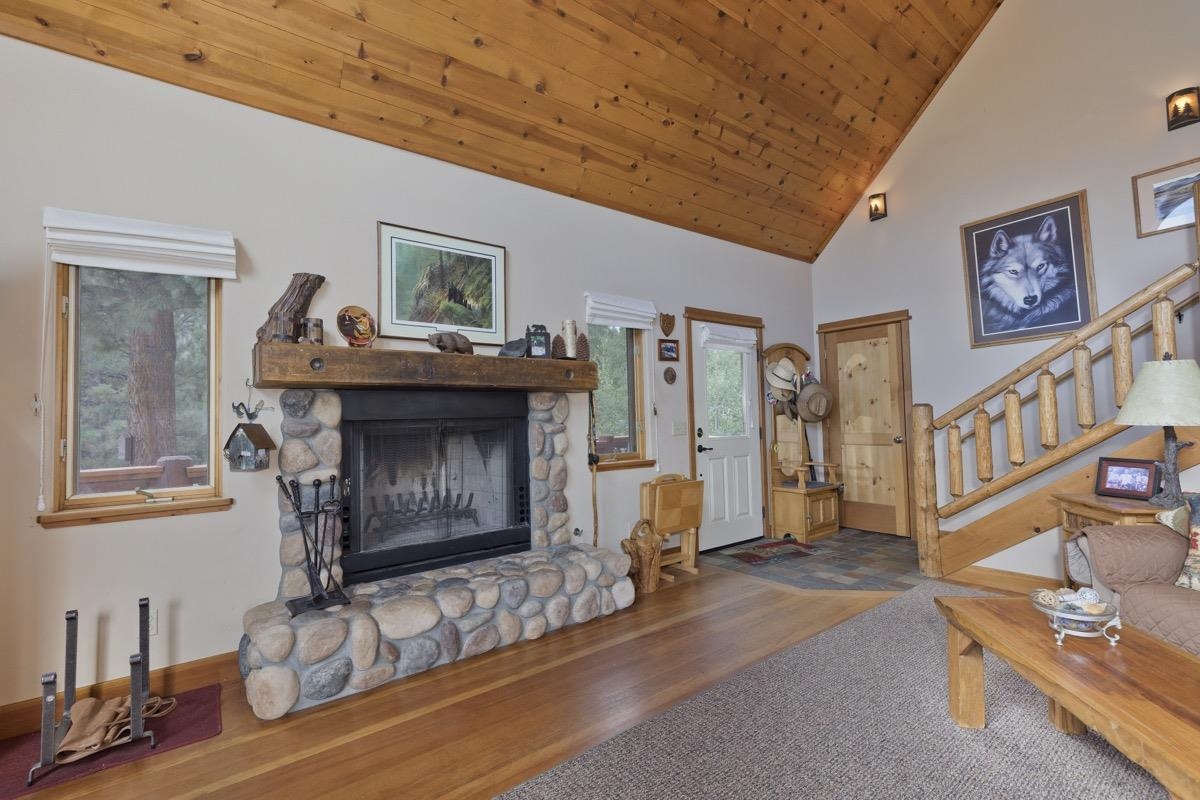 11650 Twin Lakes Road Bridgeport, CA 93517 - Photo 9 of 39 Living area with wooden ceiling, a stone fireplace, stairs, wood finished floors, and high vaulted ceiling