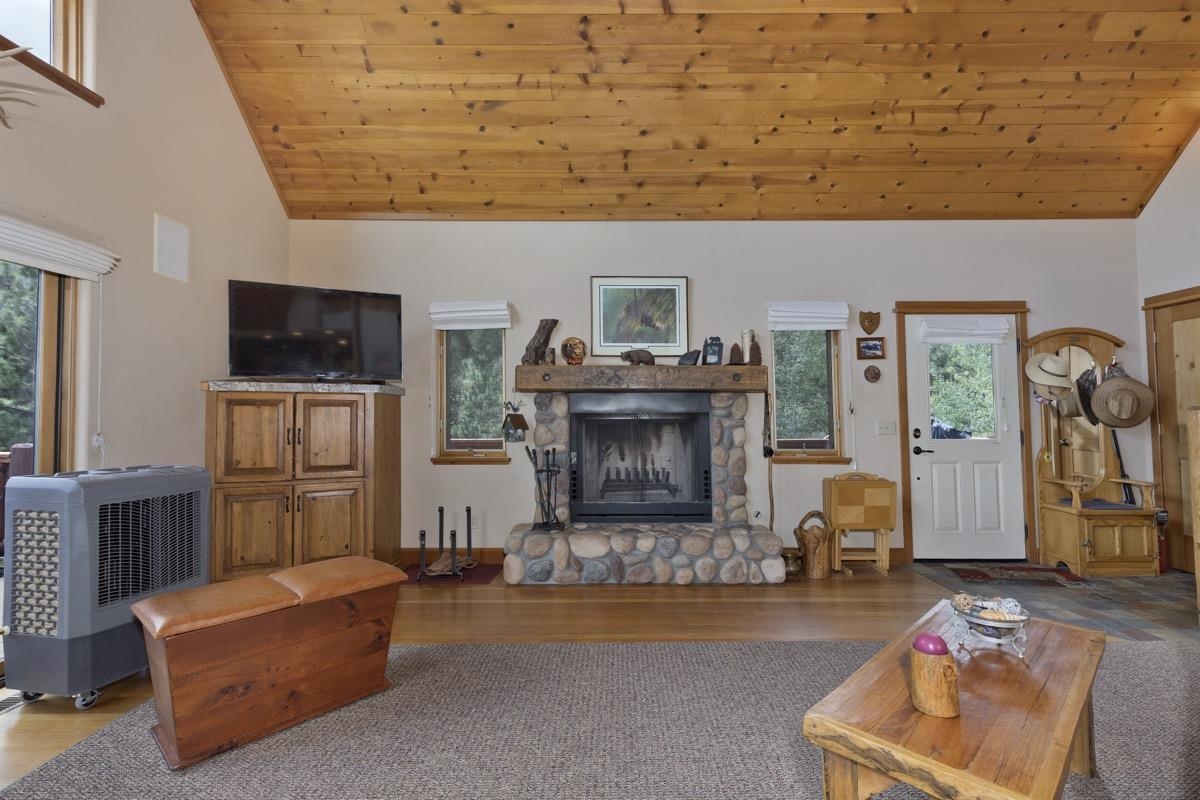 11650 Twin Lakes Road Bridgeport, CA 93517 - Photo 10 of 39 Living area featuring wooden ceiling, a stone fireplace, high vaulted ceiling, and wood finished floors