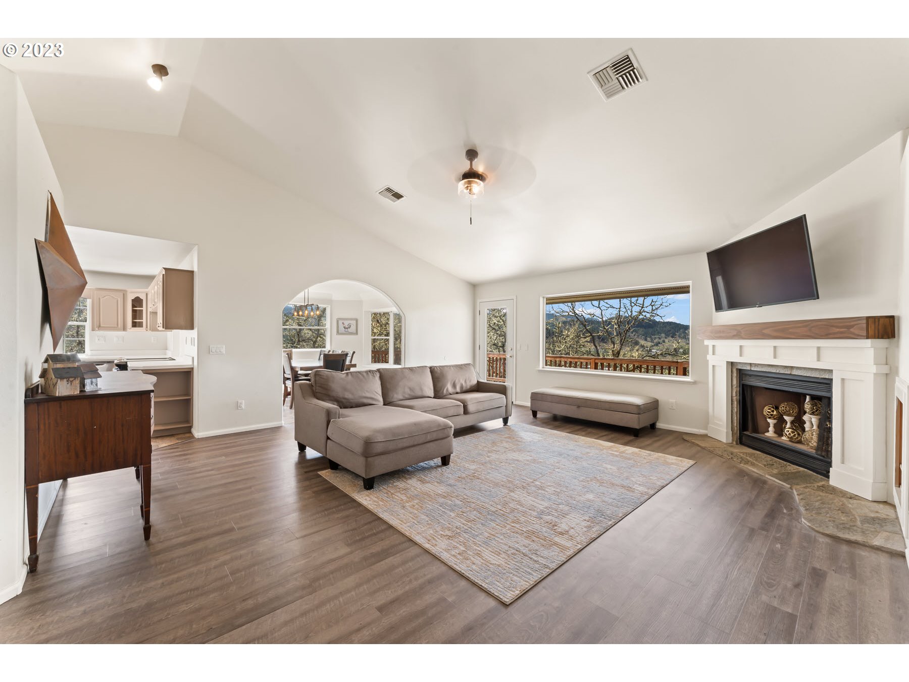 1722 Plat K Road Sutherlin, OR 97479 - Photo 2 of 32 a living room with furniture a fireplace and a flat screen tv