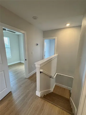 a view of a room with wooden floor