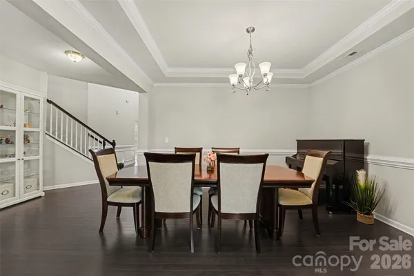 a view of a dining room with furniture wooden floor and chandelier