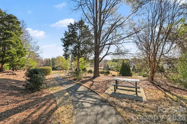 a wooden bench sitting in middle of a yard