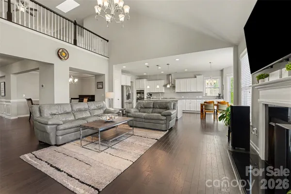 a living room with fireplace furniture and a flat screen tv