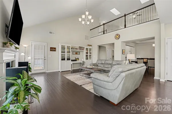 a living room with furniture a large window and a flat screen tv