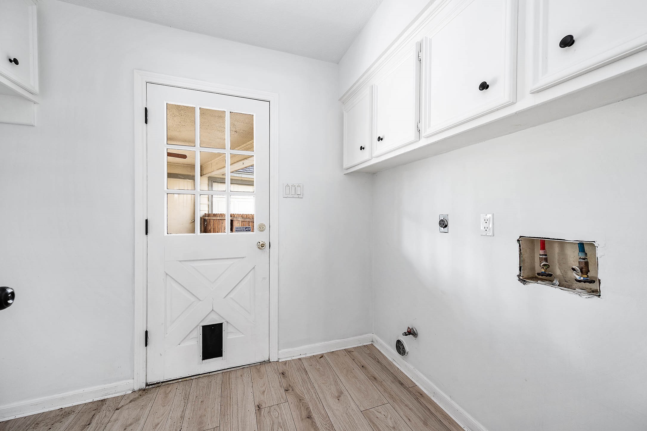 17627 Terrawren Lane Spring, TX 77379 - Photo 14 of 30 a view of kitchen with wooden floor and white cabinet
