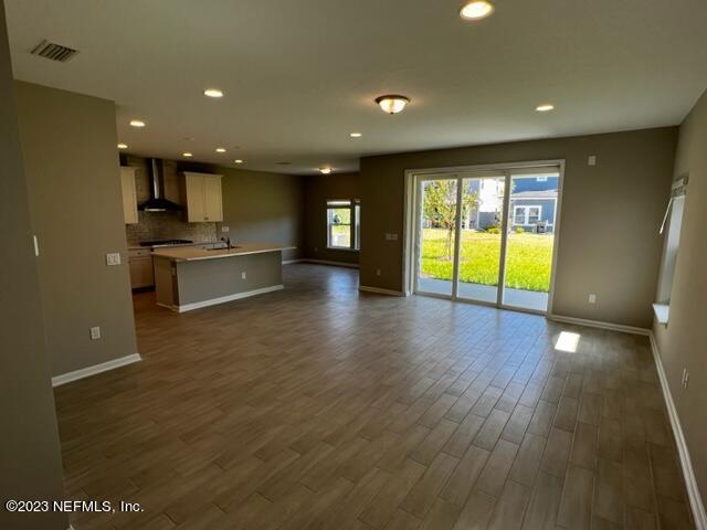 47 Goldcrest Way St. Augustine, FL 32092 - Photo 4 of 10 a view of an empty room with window and wooden floor