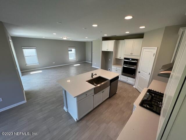 47 Goldcrest Way St. Augustine, FL 32092 - Photo 6 of 10 a large kitchen with stainless steel appliances a large counter top a stove and a refrigerator