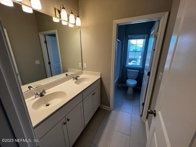 47 Goldcrest Way St. Augustine, FL 32092 - Photo 10 of 10 a bathroom with a double vanity sink mirror and toilet