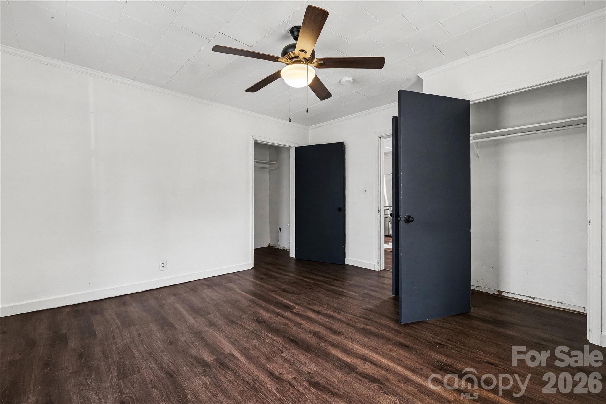 1175 Old Salisbury-Concord Road Concord, NC 28025 - Photo 11 of 31 a view of an empty room with wooden floor and a ceiling fan