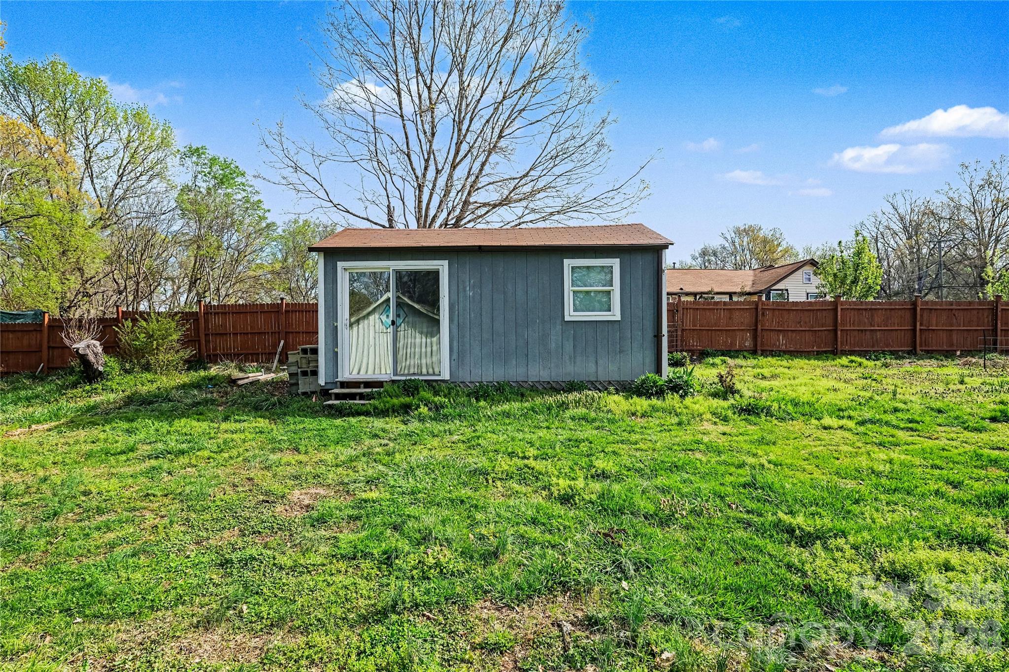 1175 Old Salisbury-Concord Road Concord, NC 28025 - Photo 27 of 31 a brick house next to a yard with a large tree