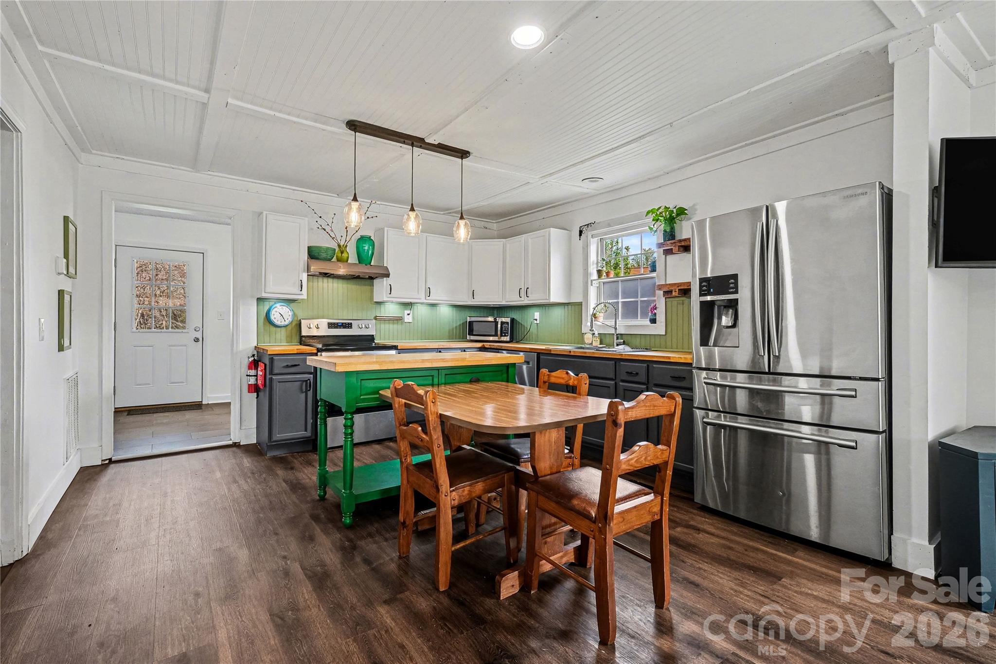 1175 Old Salisbury-Concord Road Concord, NC 28025 - Photo 7 of 31 a kitchen with kitchen island a dining table and chairs