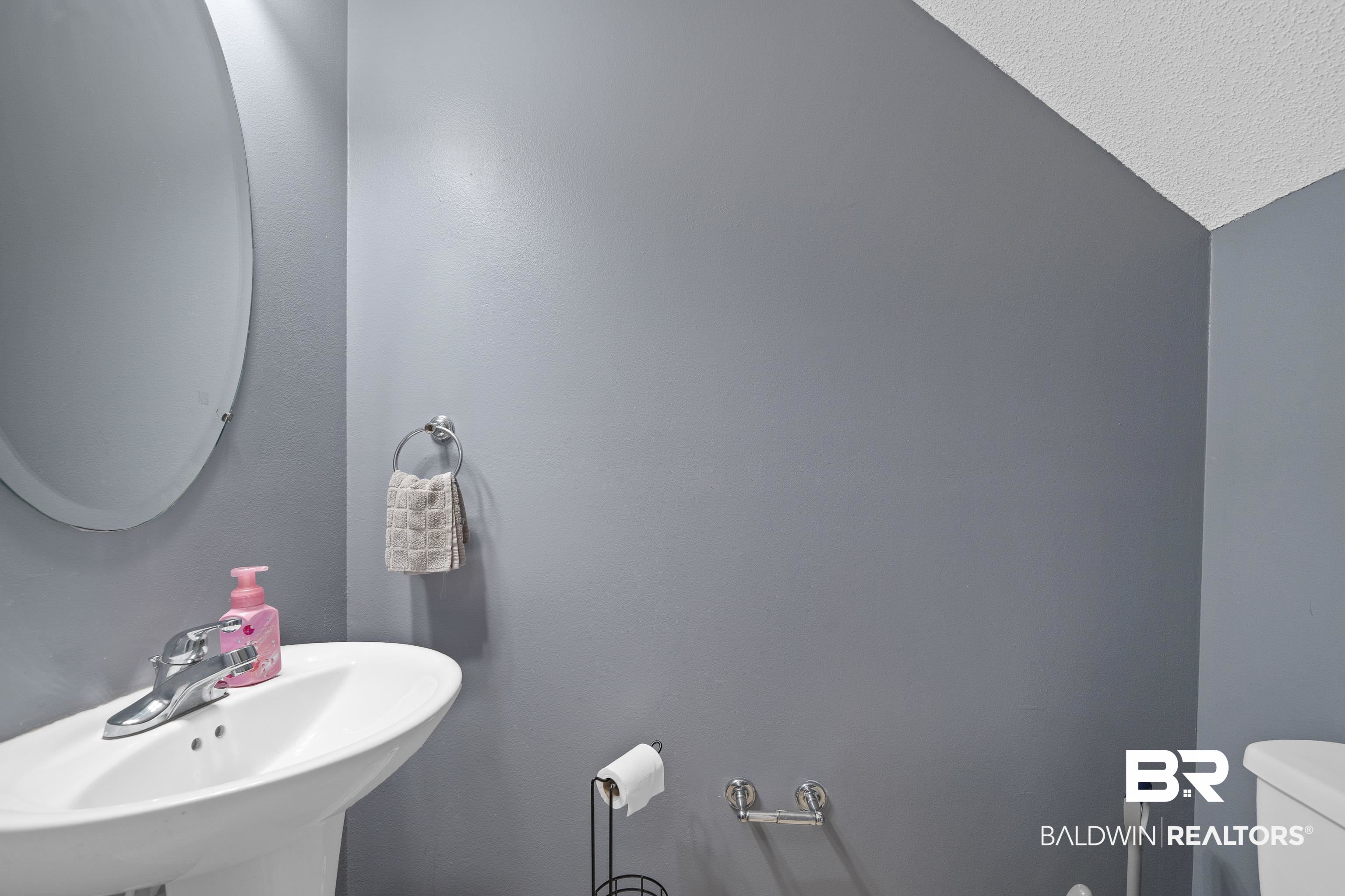 9552 Collier Loop Daphne, AL 36526 - Photo 15 of 28 Bathroom with a sink, toilet, and a textured ceiling
