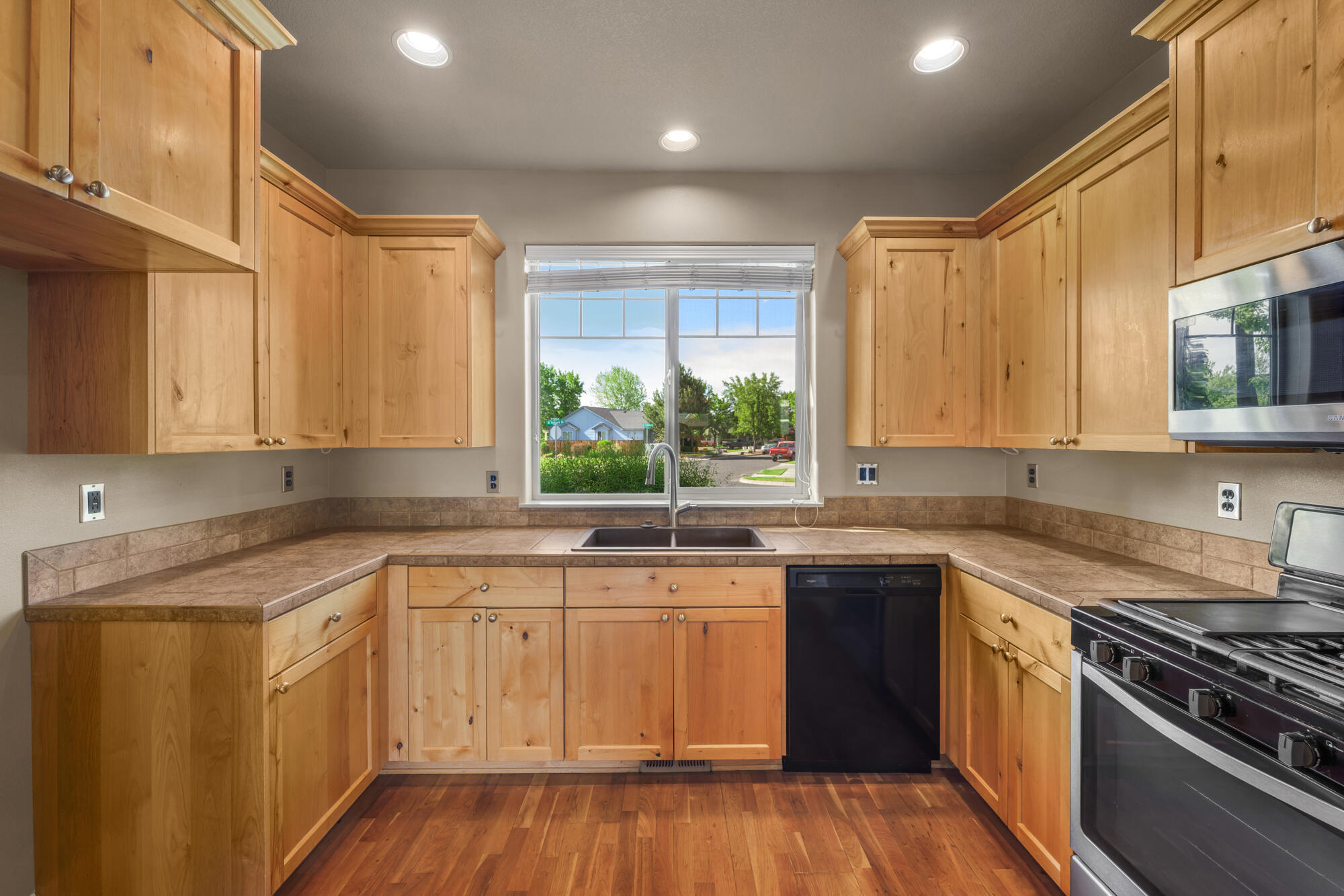 1402 Northeast Hudspeth Road Prineville, OR 97754 - Photo 13 of 36 a kitchen with a sink stove top oven and cabinets