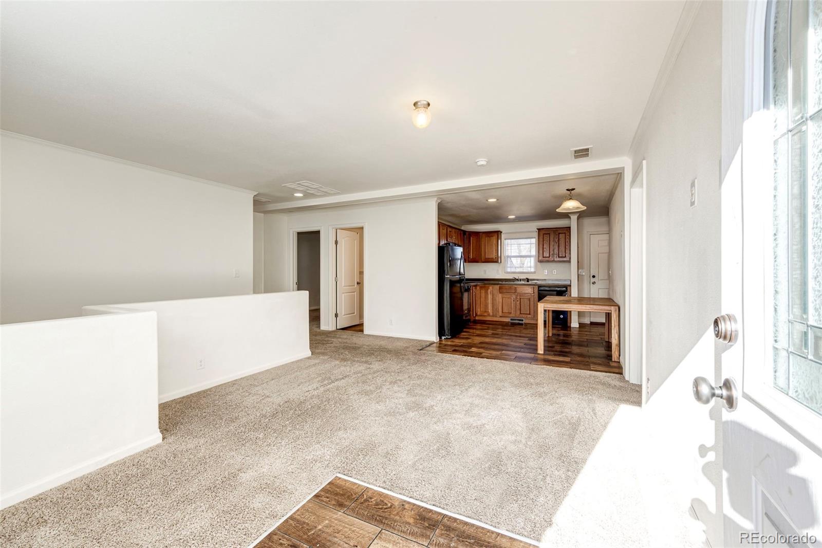 574 4th Street Bennett, CO 80102 - Photo 13 of 24 a view of a bedroom with kitchen and sink