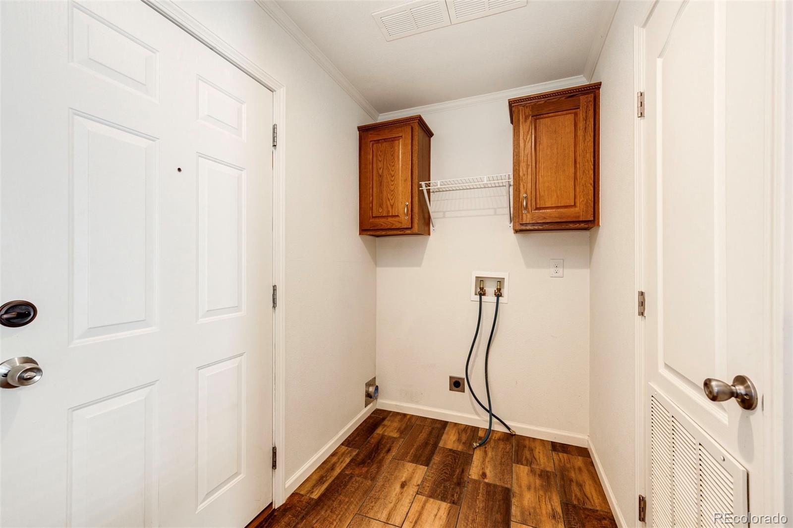 574 4th Street Bennett, CO 80102 - Photo 20 of 24 a room with a table and a mirror