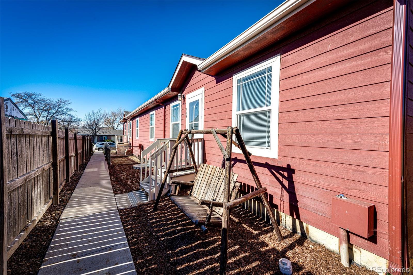 574 4th Street Bennett, CO 80102 - Photo 2 of 24 a view of a patio with wooden floor and iron stairs