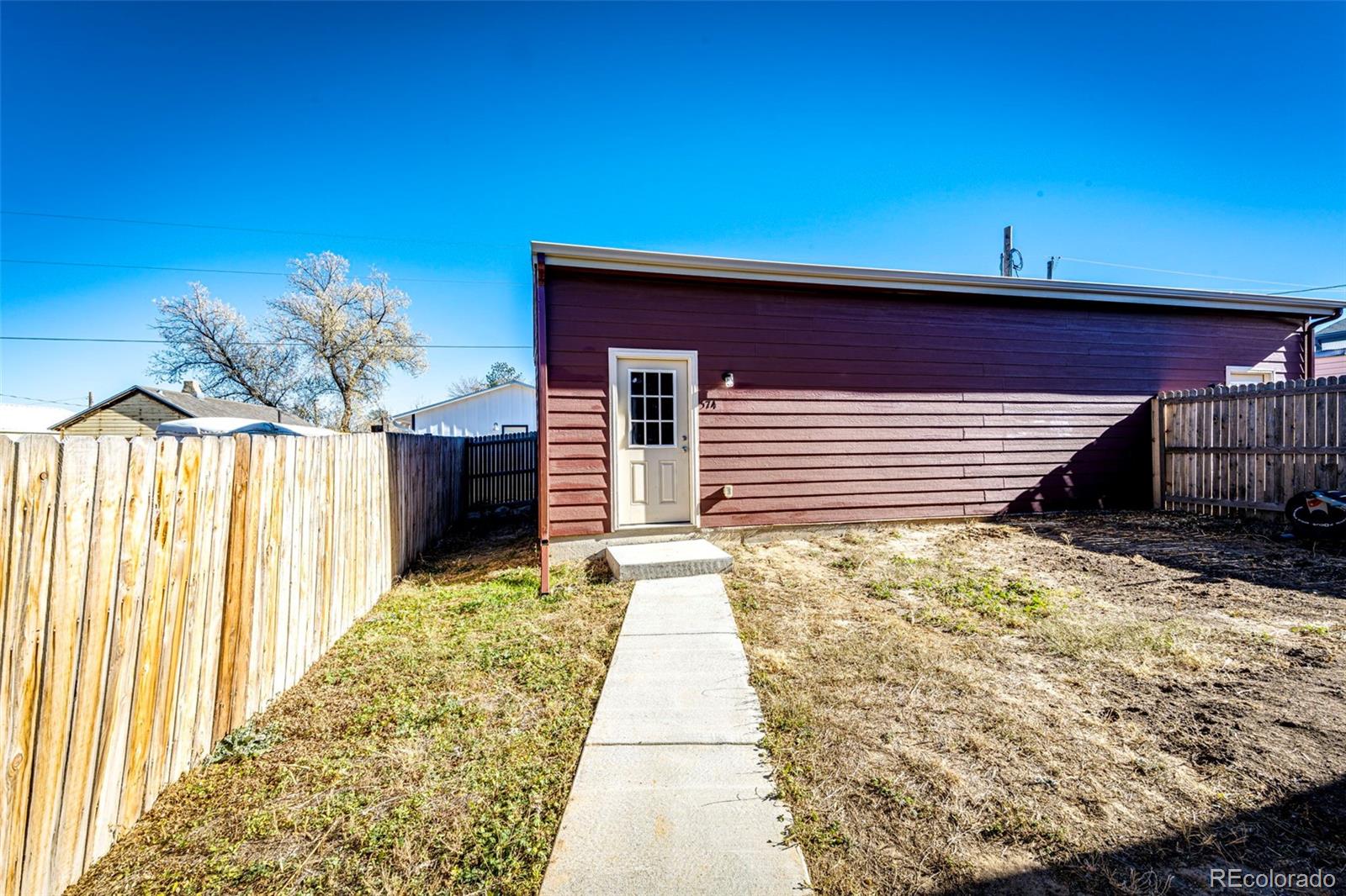 574 4th Street Bennett, CO 80102 - Photo 3 of 24 a front view of a house with a yard
