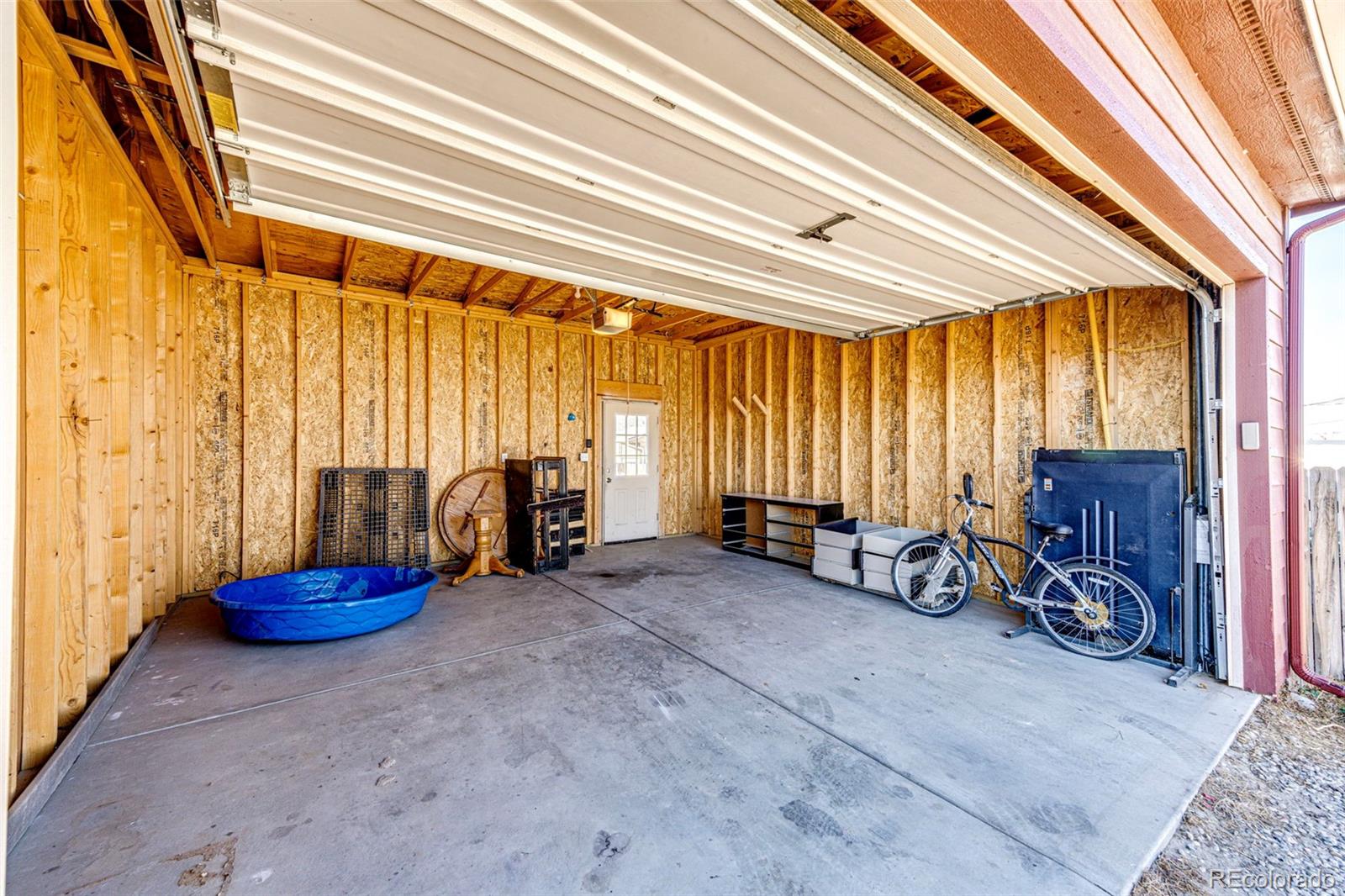 574 4th Street Bennett, CO 80102 - Photo 7 of 24 a view of a room with gym equipment and a large window