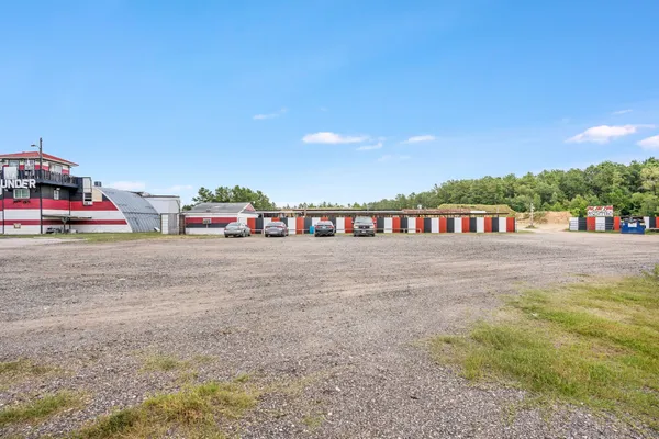 a view of a house with a big yard and large trees