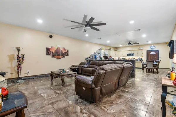 a kitchen with a table chairs a sink dishwasher stove and cabinets with wooden floor