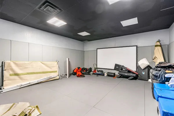 a room with gym equipment and lots of equipment