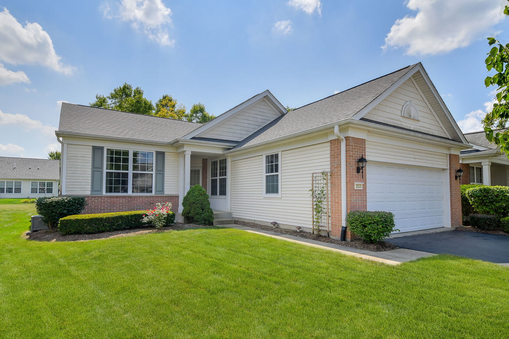 a front view of a house with a yard and outdoor seating