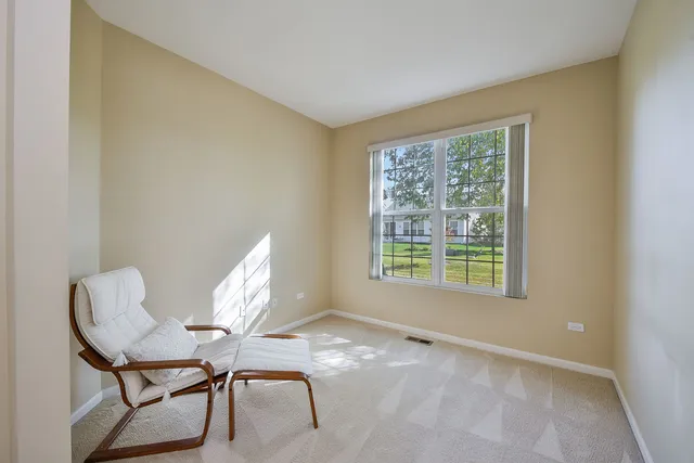 a workspace room with furniture and a window