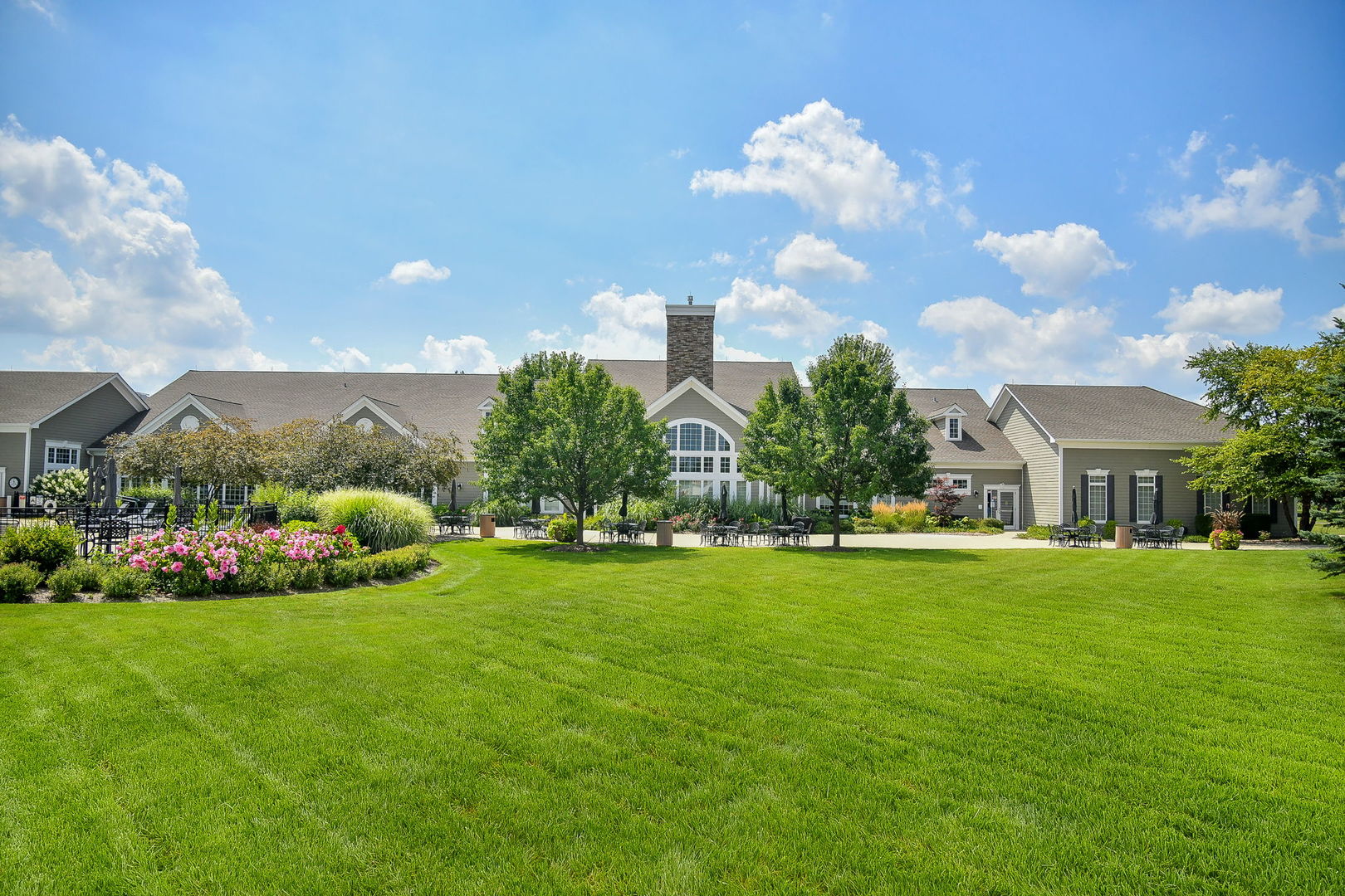 2525 Rolling Ridge Elgin, IL 60124 - Photo 25 of 26 a front view of a house with garden and trees
