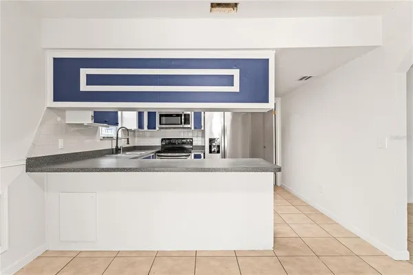 a view of kitchen with granite countertop window and outdoor view