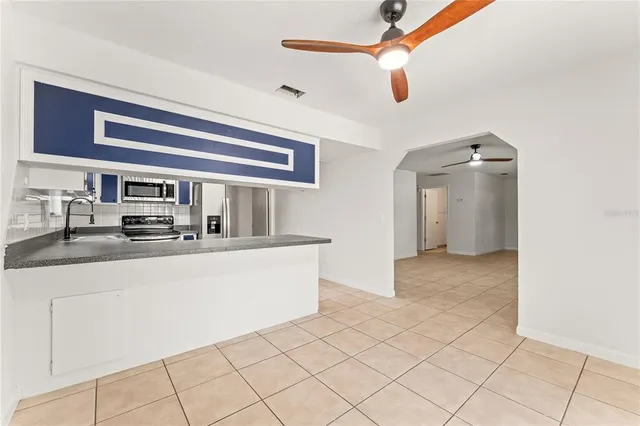 a view of living room with granite countertop furniture and a ceiling fan