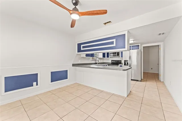 a kitchen with stainless steel appliances a sink and a refrigerator