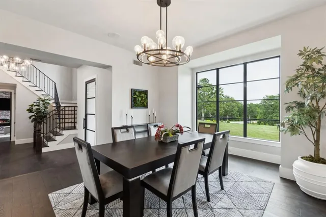 a dining room with furniture a chandelier and wooden floor